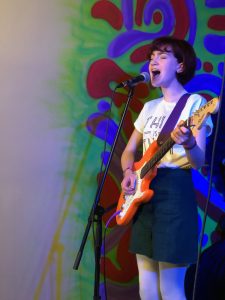 Ella singing on stage