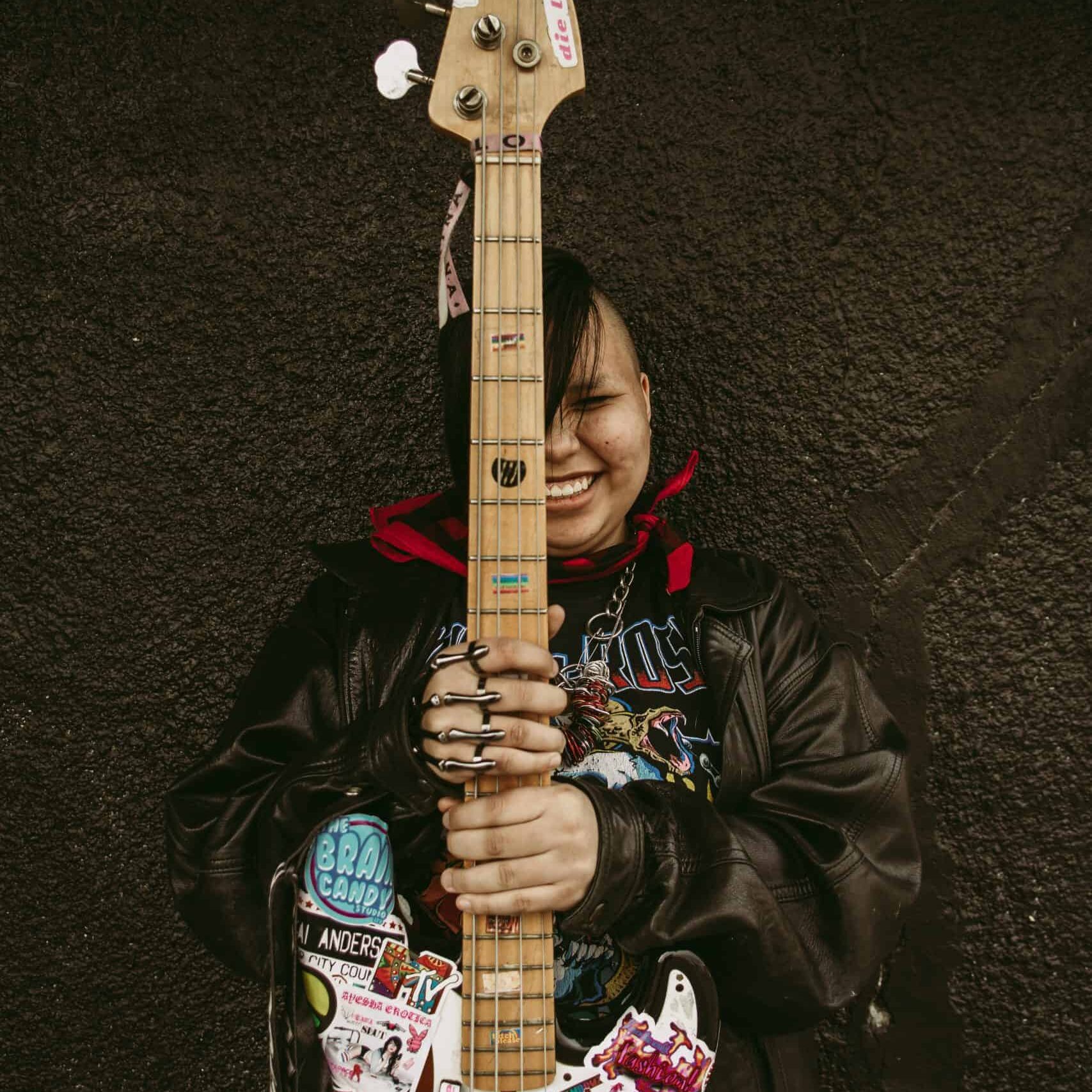 Lilah Davis holding electric bass upright. Edmonton, AB Lilah Davis holding electric bass upright. Edmonton, AB