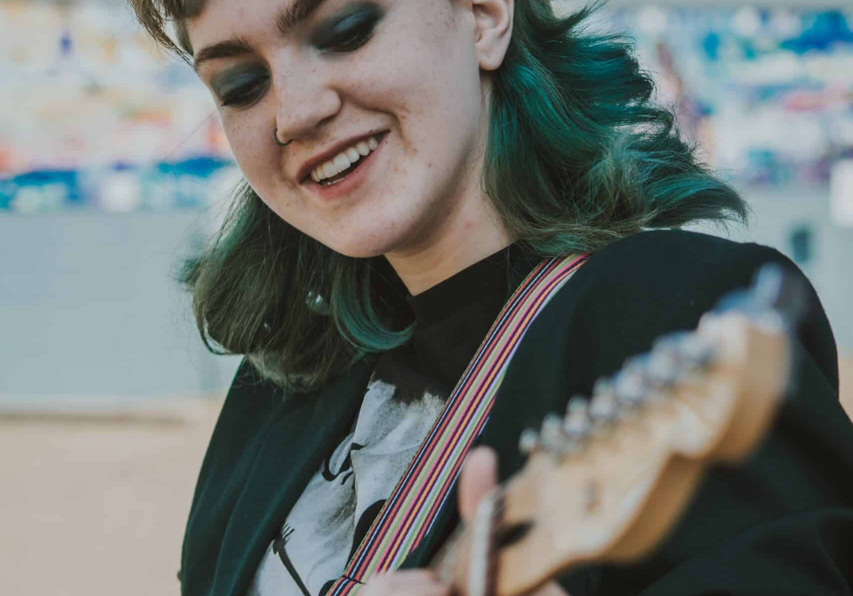 Ella Raven-Jackson playing guitar Ella Raven-Jackson